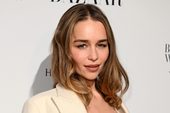 Emilia Clarke at the Harper's Bazaar Women of the Year 2023 event, wearing a stylish white blazer over a low-cut top