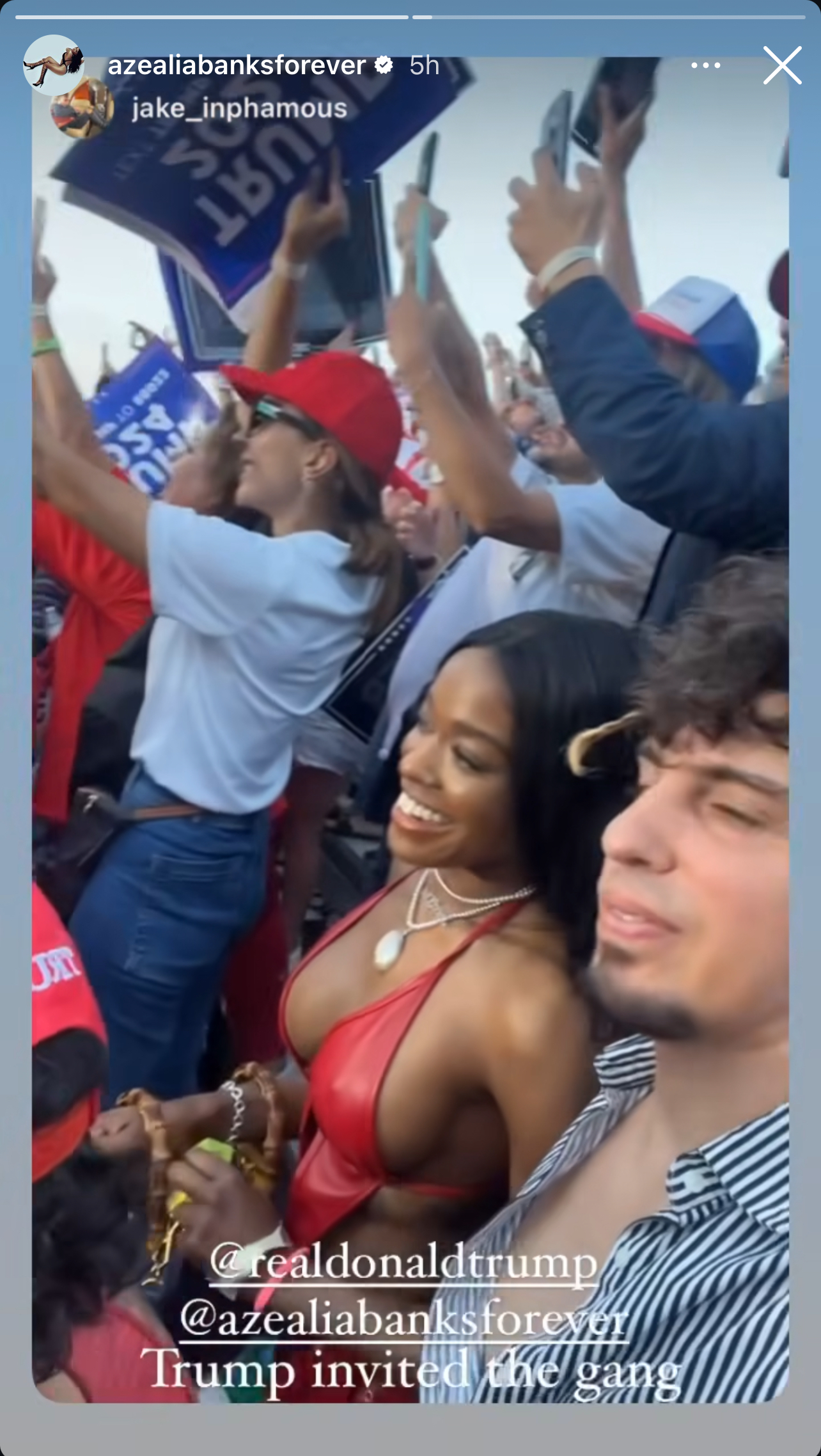 Azealia Banks in a red top at a crowded outdoor event with Jake Infamous. People in the background hold &quot;Trump 2024&quot; signs. Text includes &quot;Trump invited the gang.&quot;