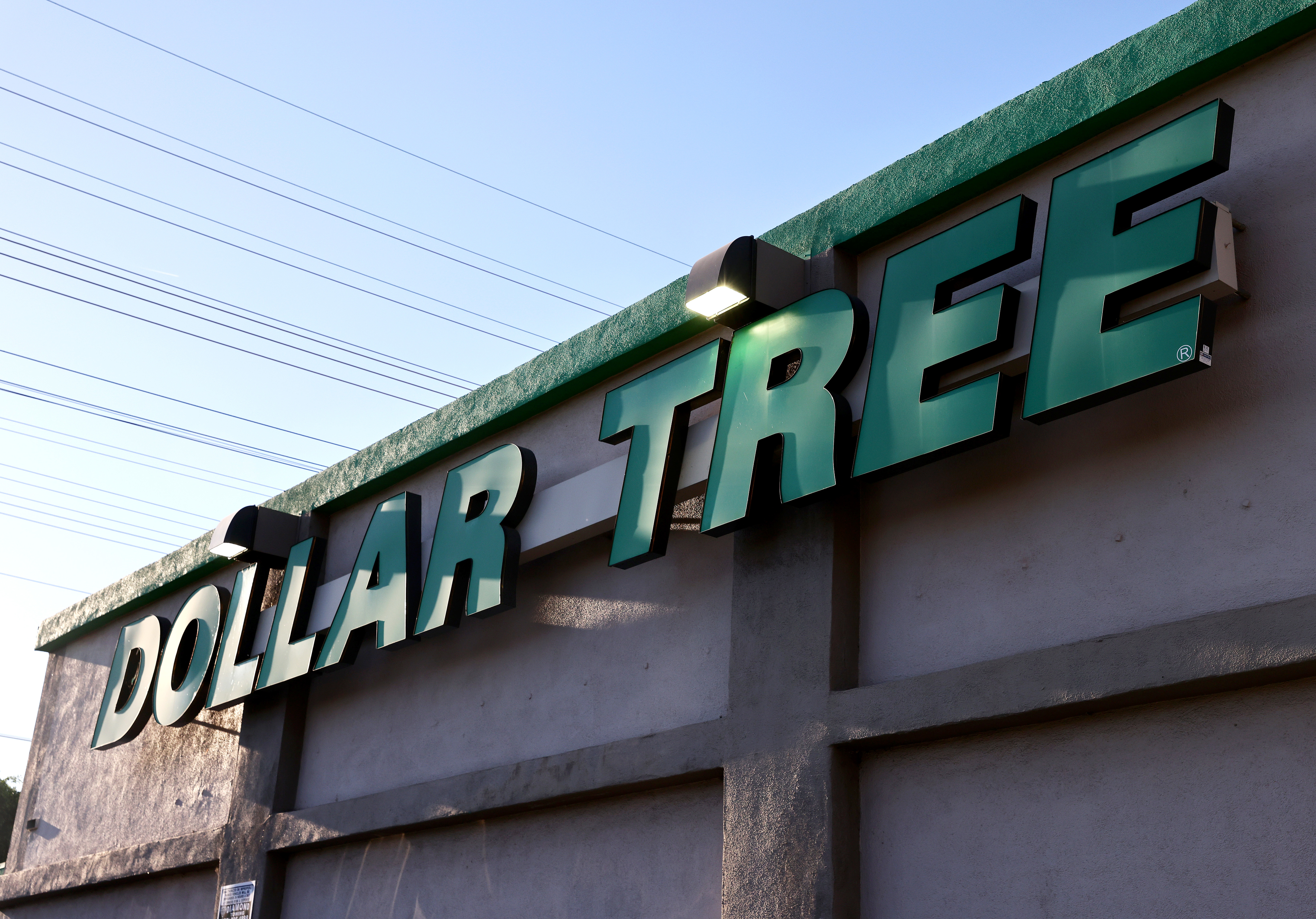 The image shows the exterior of a Dollar Tree store with the store&#x27;s sign prominently displayed