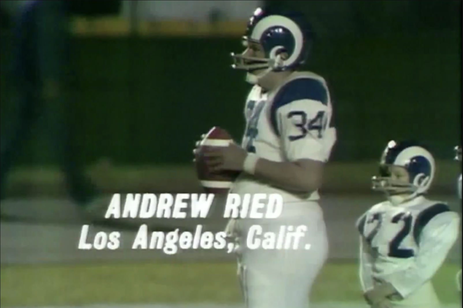 Andrew Ried, wearing a football uniform, prepares to throw a football. A smaller player in a similar uniform stands nearby. Both are from Los Angeles, Calif